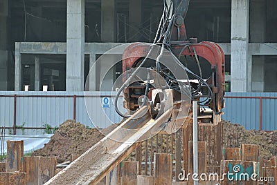 Steel sheet pile cofferdam machine at the construction site. Editorial Stock Photo